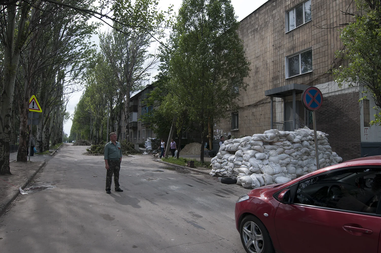 Man guarding the checkpoint located on the edge of the airport's roadblock 