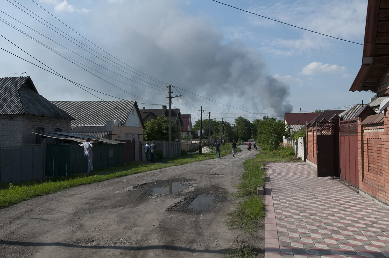 People looking at the smoke coming from the airport area, this neighborhood is located between Donetsk's train station and its airport.