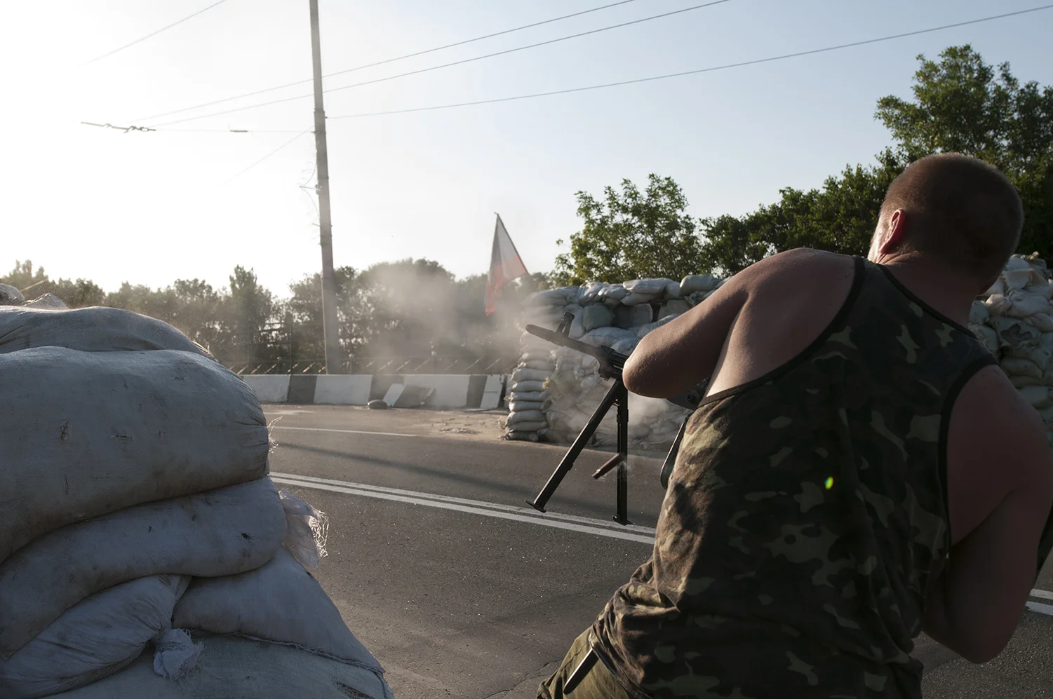 DPR solider firing with his light machine gun in direction of the airport.