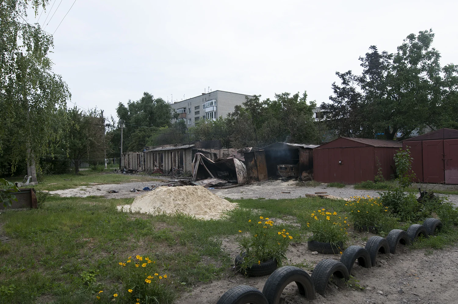 Garages hit during the night between by artillery fire the 11 and 12 of July in a residential neighbourhood of Marinka which is located 30Km west from Donetsk city center. Three civilians died during this attack 