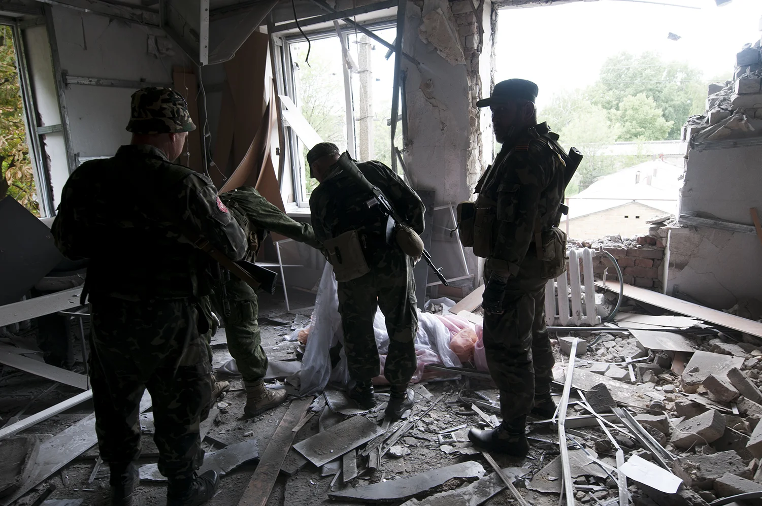 Separatist squad looking over the life less body of a security guard they came to retrive 