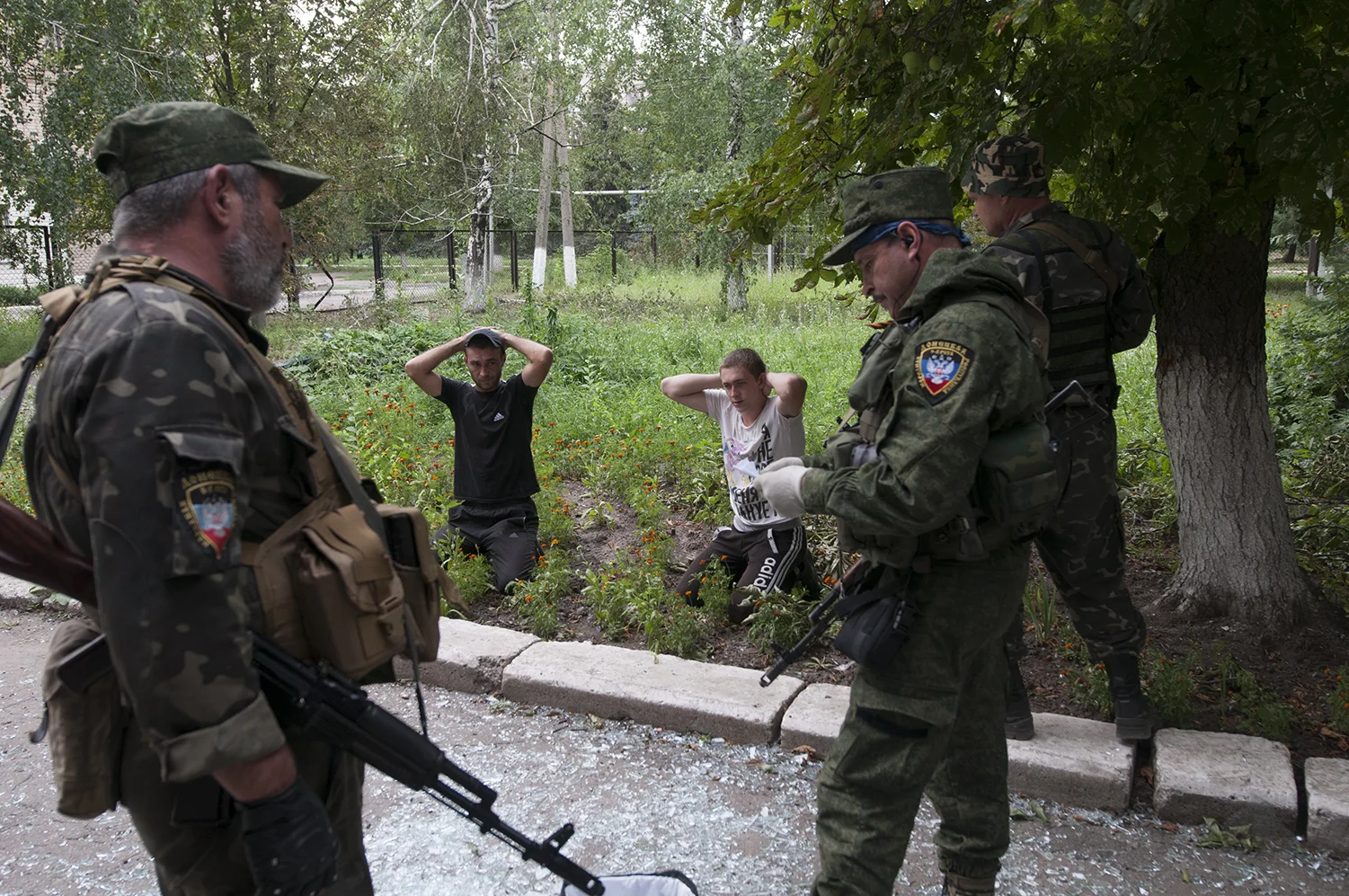 The deputy commander checking the passport belonging to one of the looters 