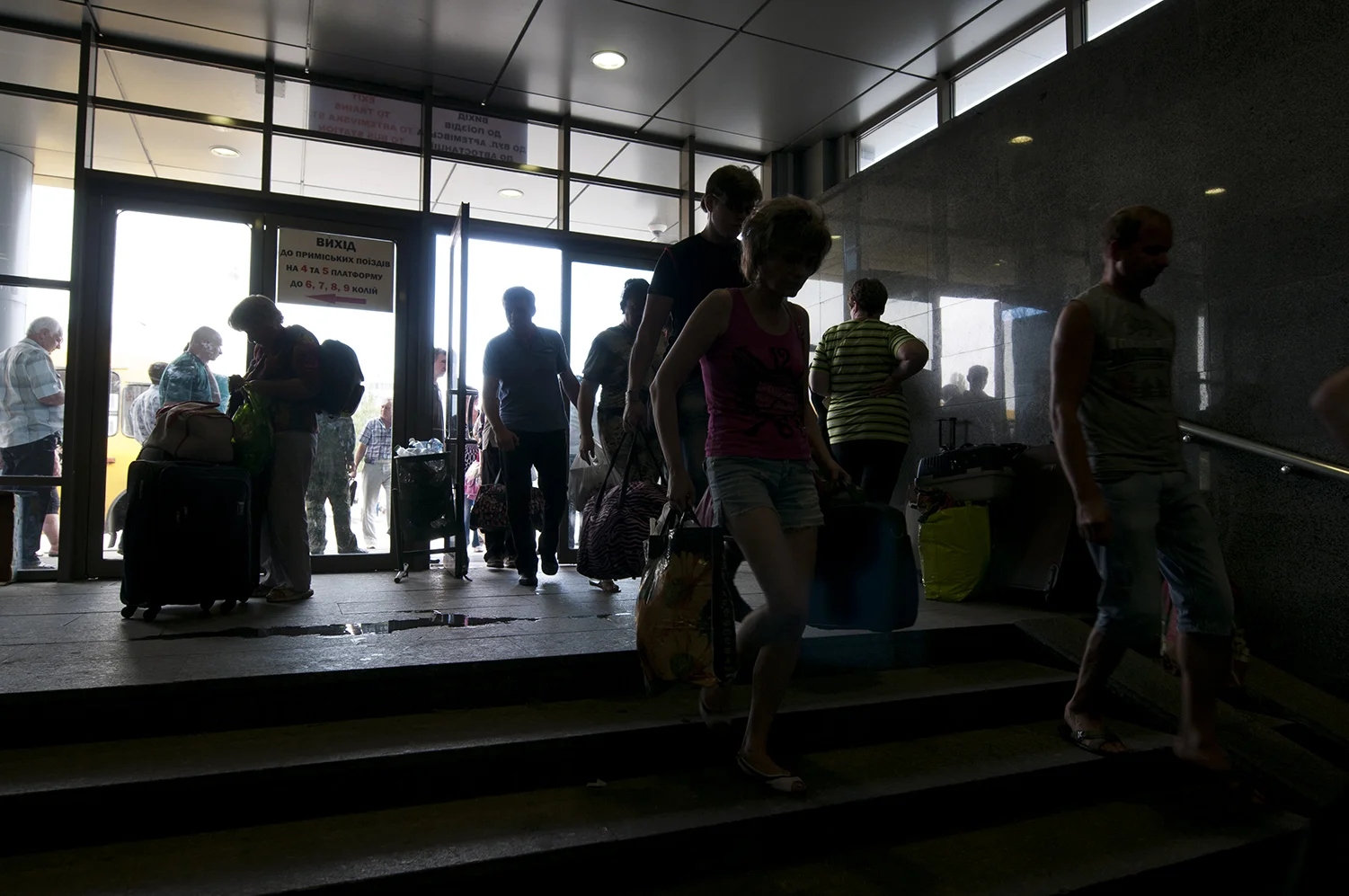 People going inside the train station to wait for the departure of their train 
