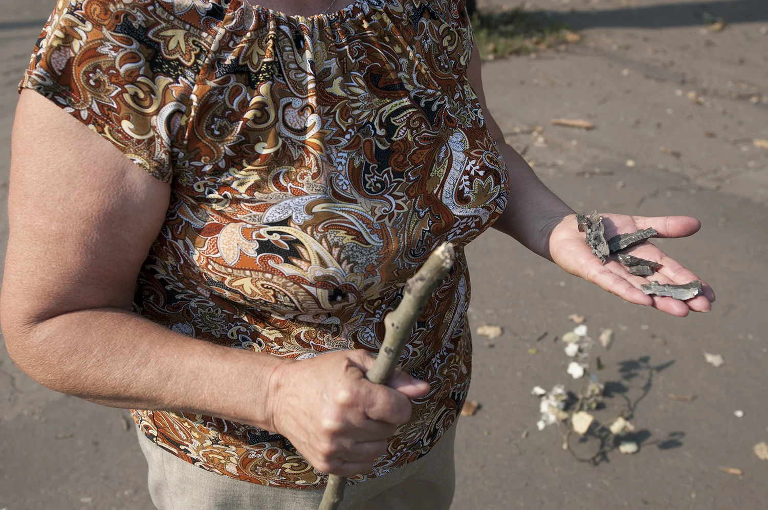 A local woman showing pieces of shrapnel