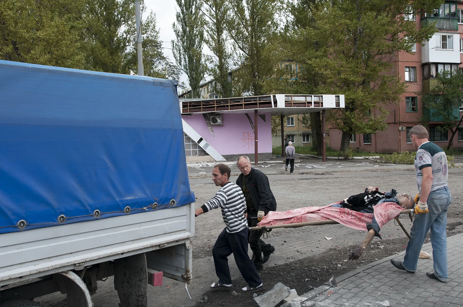 Volunteers loading the corps inside the back of their truck