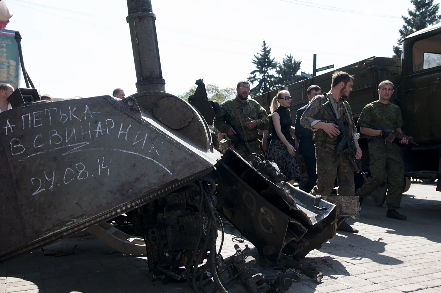 Separatists soldiers walking between the displayed Ukrainian vehicules 