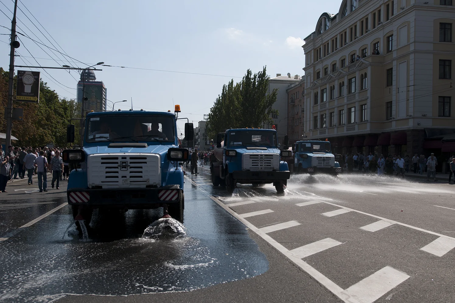 Three water trucks "cleaning" the streets after the Ukrainian prisoners