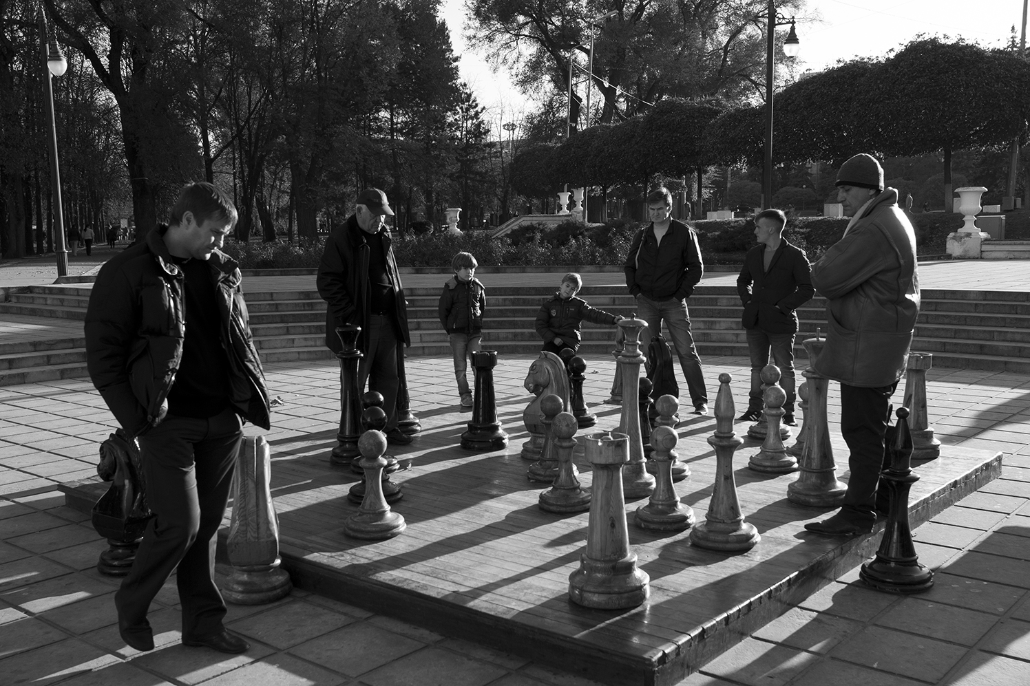 People playing on a giant chess game in the entrence of Nativity Cathedral Park