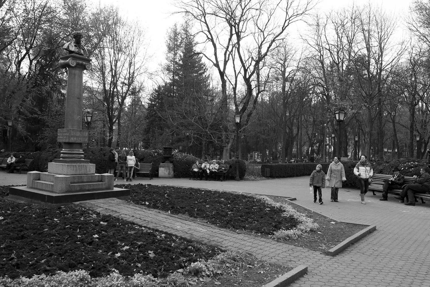 Young kid looking up at the bust of Pushkin 