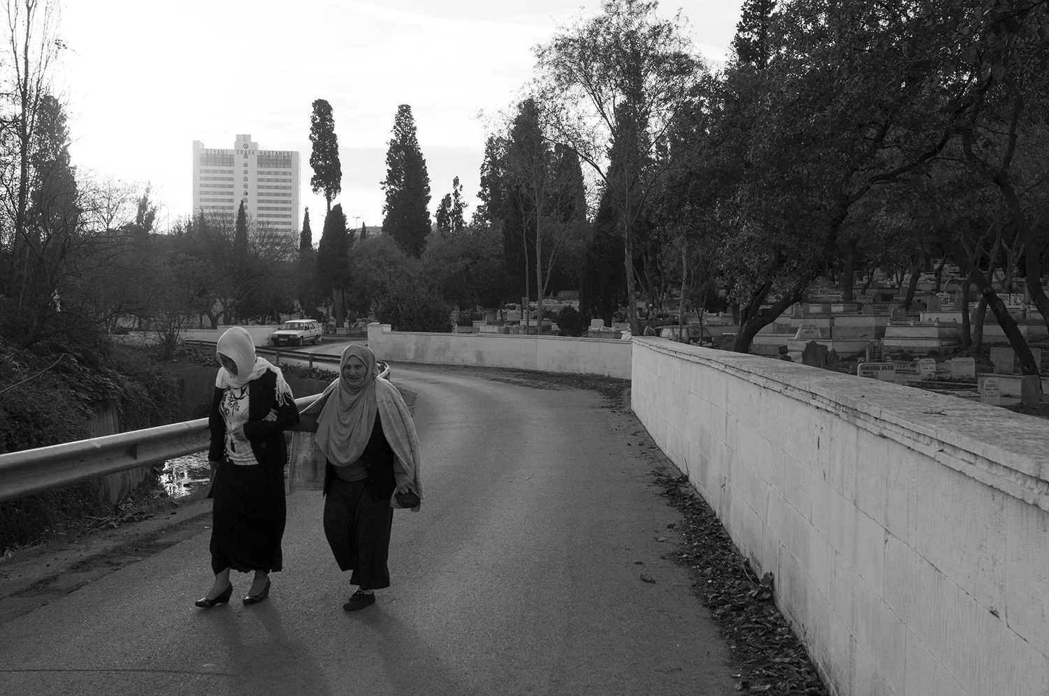 Two women walking though Karacaahmet Cemetery