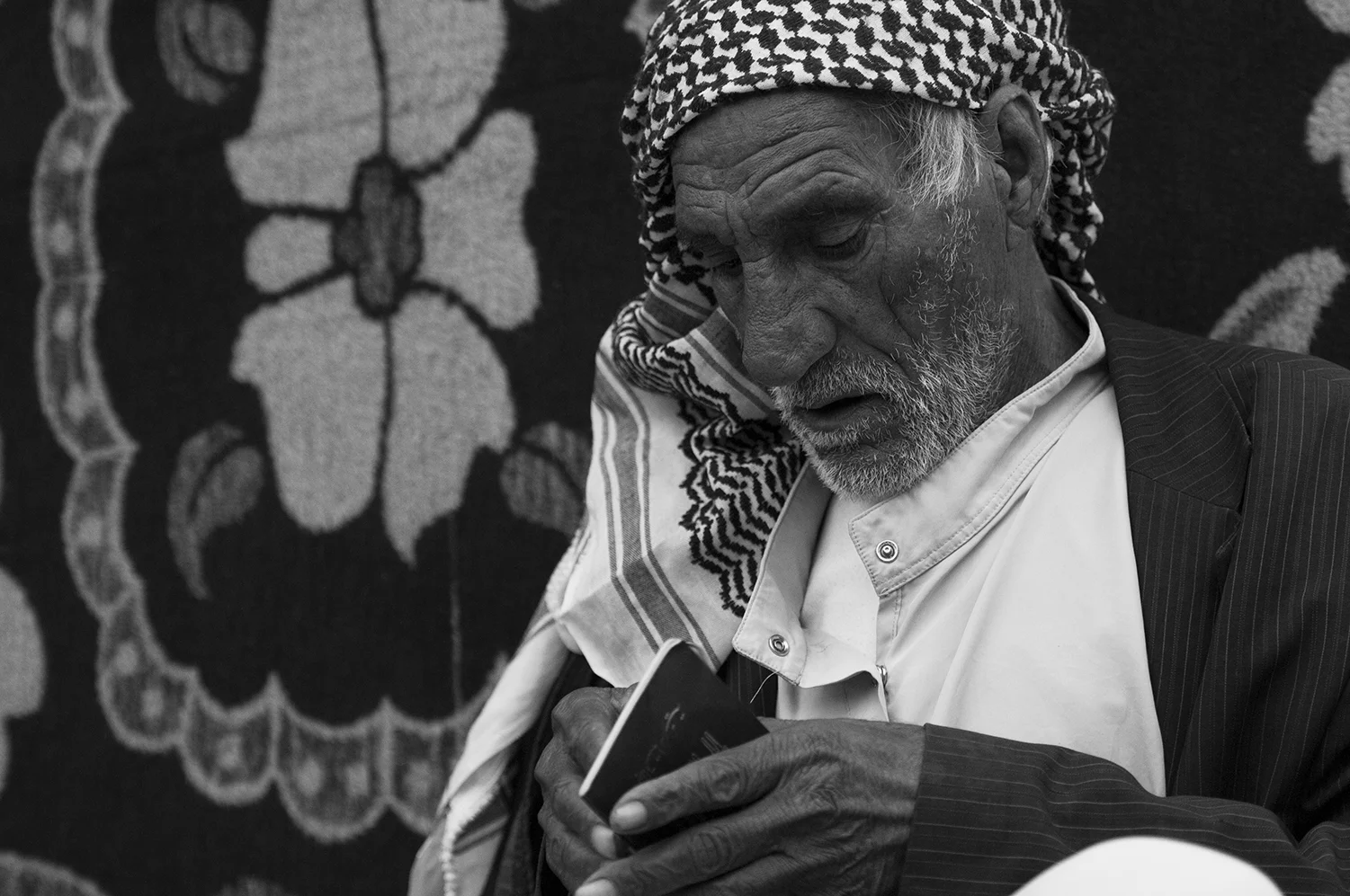 "Baram" looking at his Syrian passport