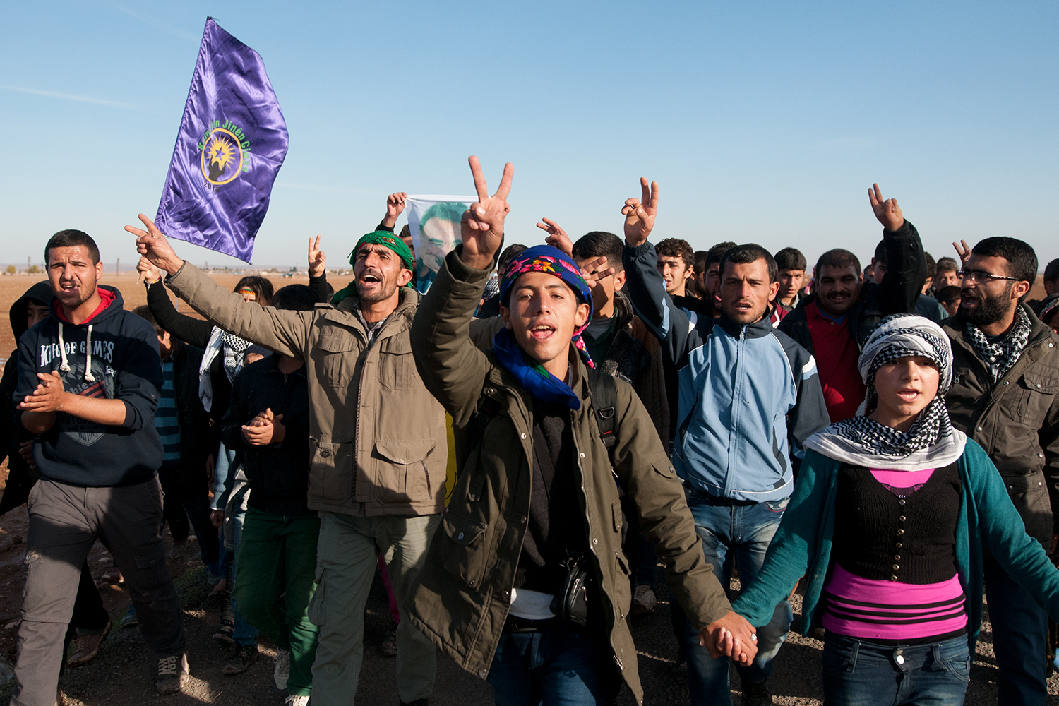 Kurdish rally marching in direction of Çaykara, a small village bordering with the Syria and the town of Kobane.