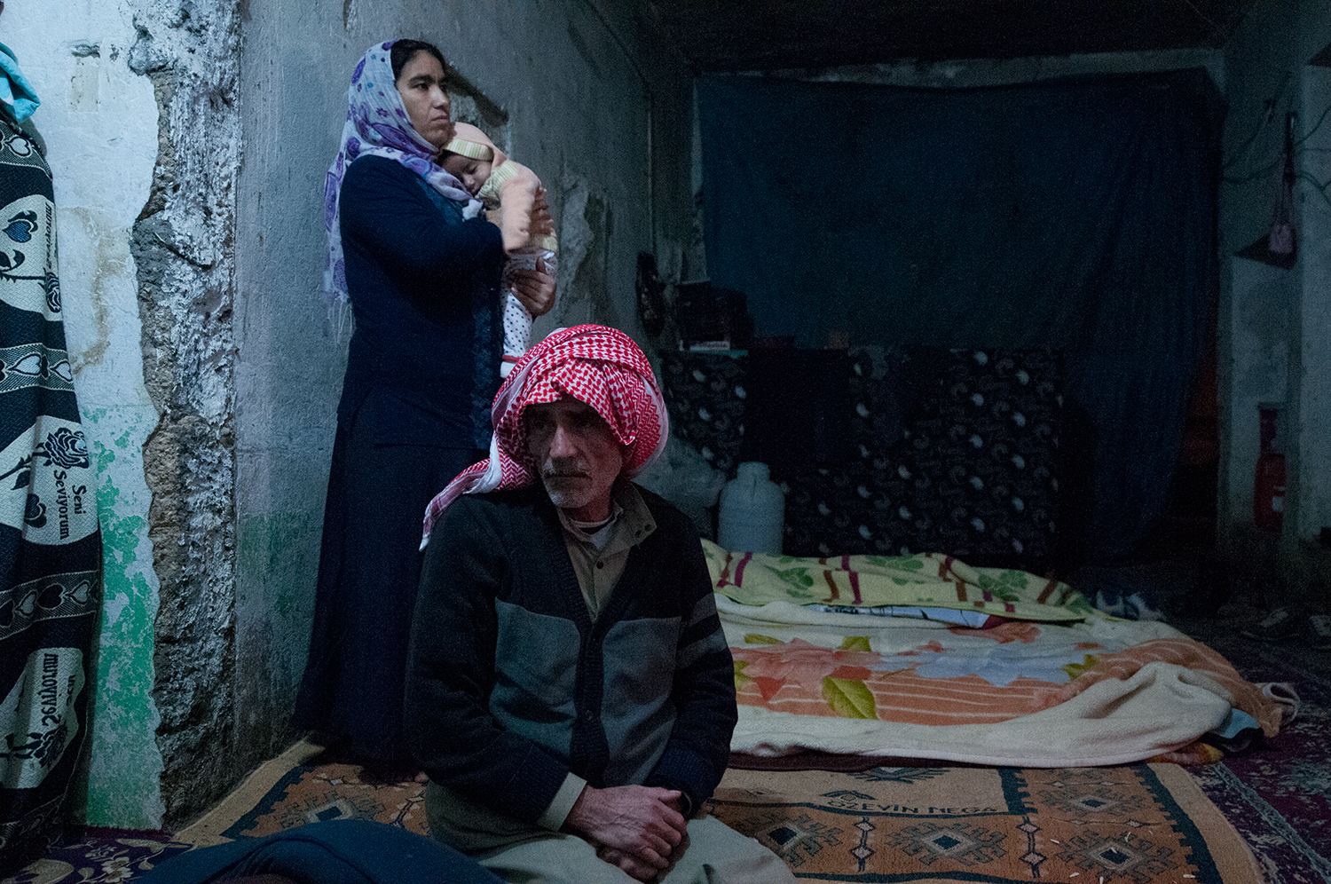 A Kurdish family from Syria living in a storage unit that they are renting in Suruç