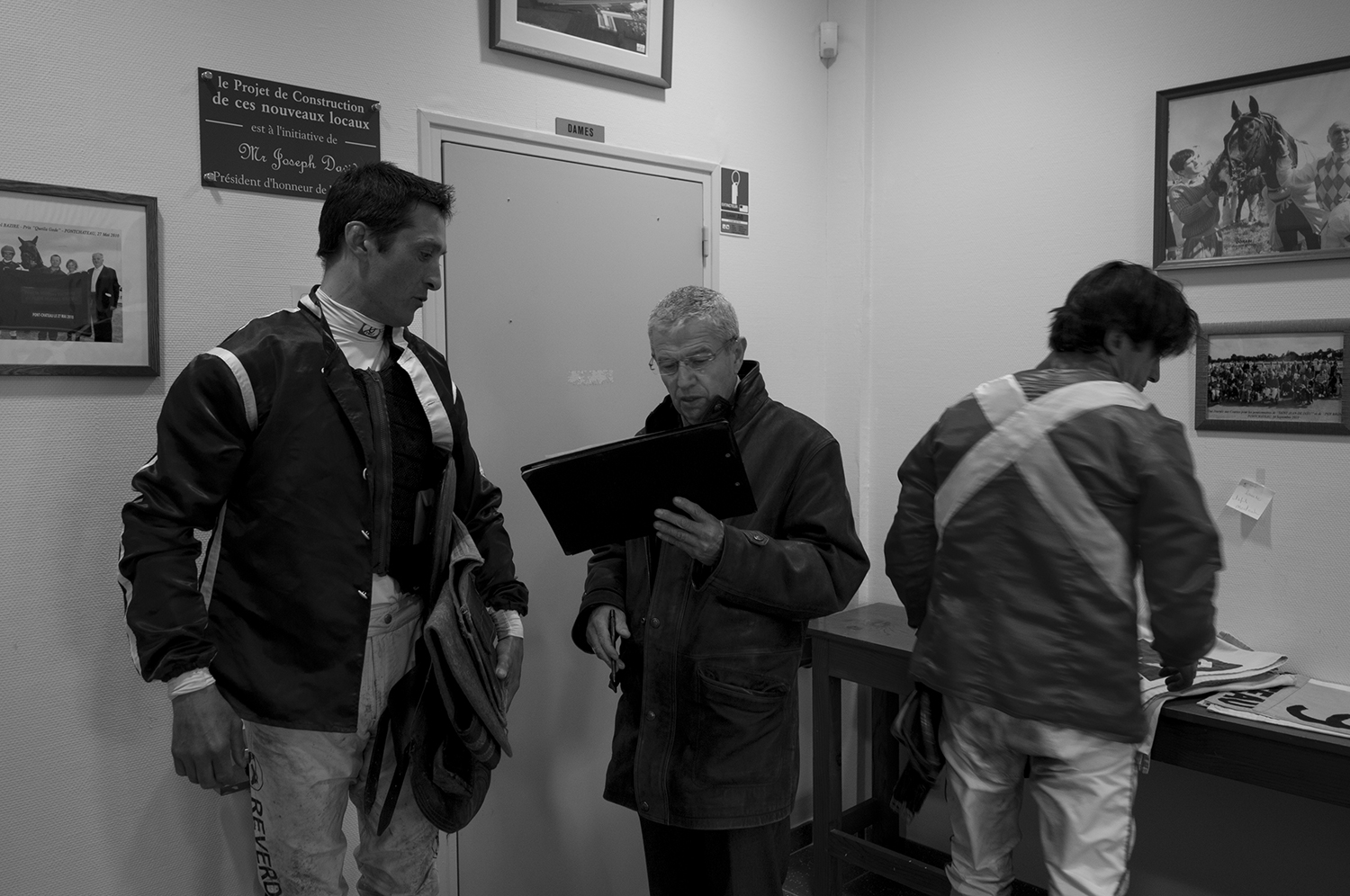 Jockeys at the weight-in supervised by a race steward.