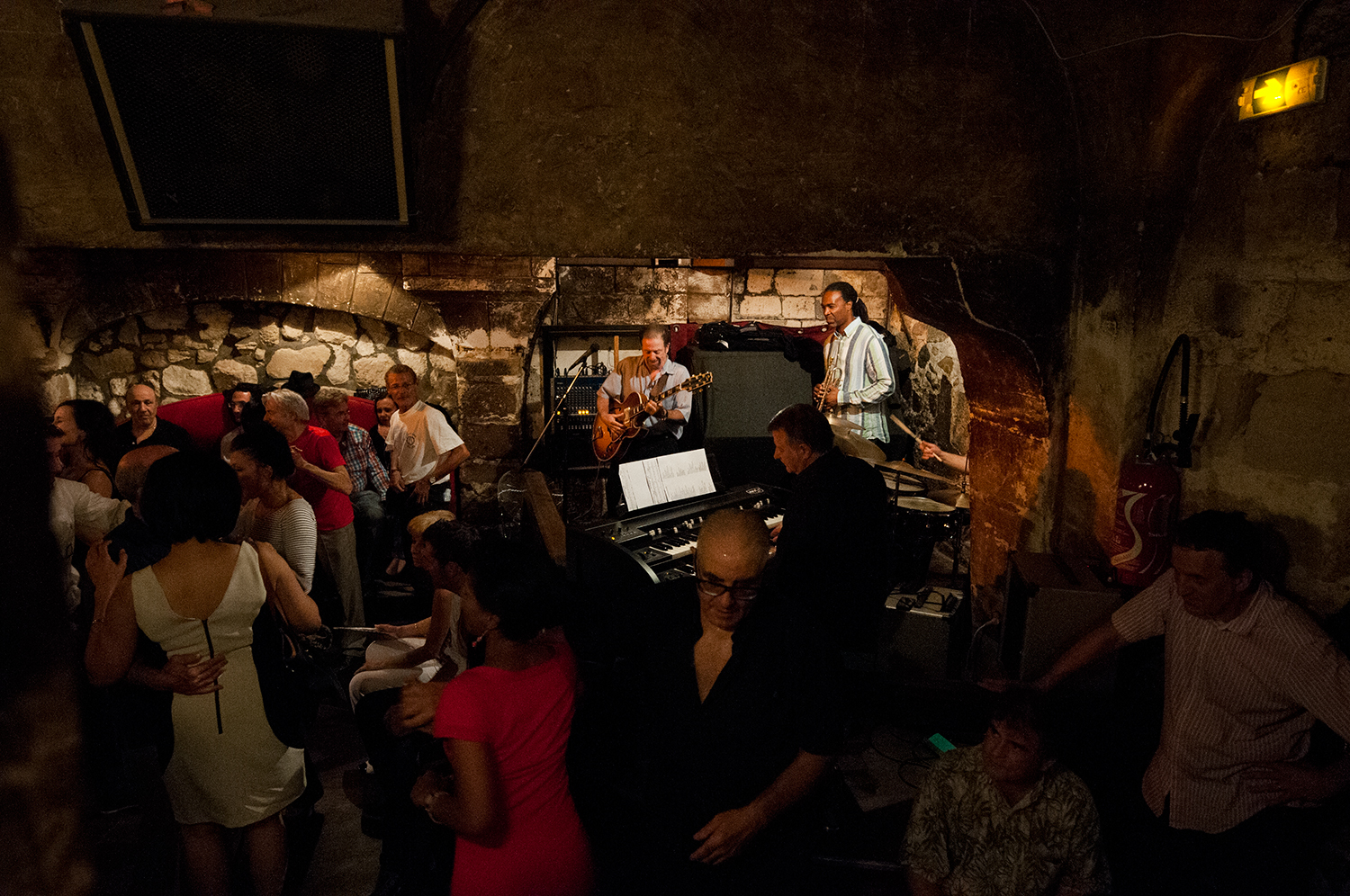 People dancing as a jazz band plays in the cellar of the Caveau De La Huchette.