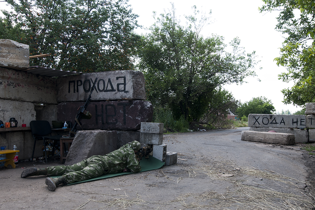 Sniper from the Patriot Battalion scouting from a checkpoint located near the front line