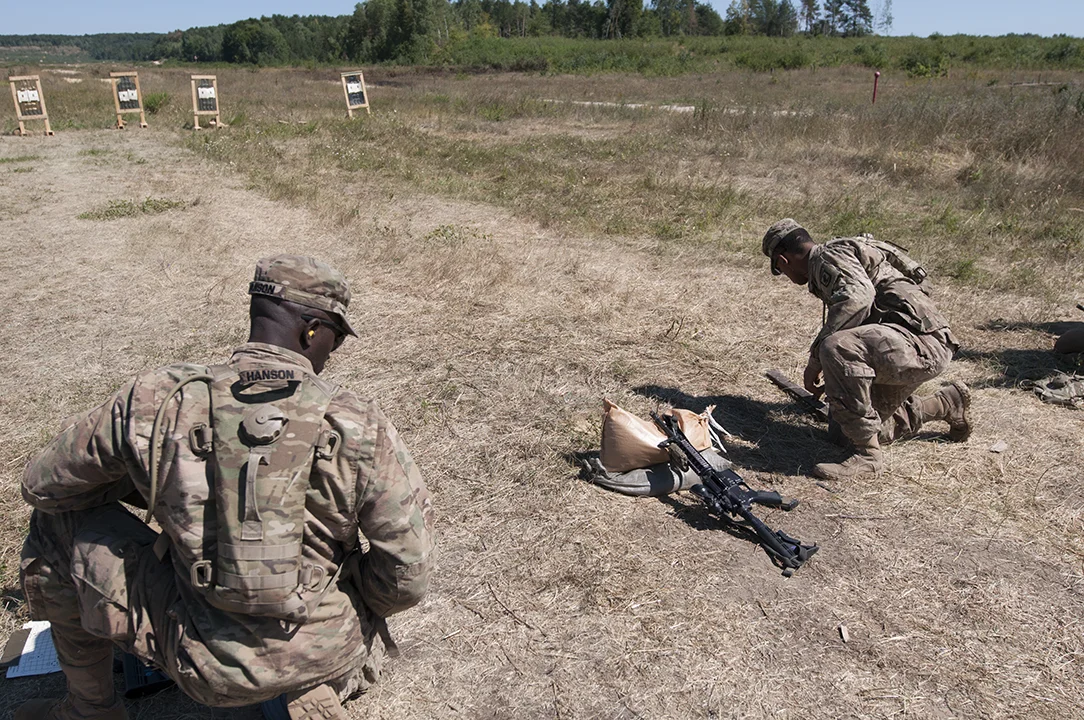 U.S. soldiers from the 173rd Airborne Brigade searching and gathering their ammunition casings.