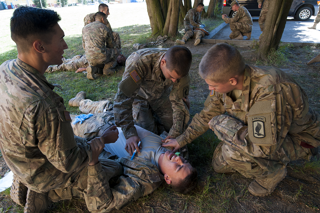 Officer supervising the medical training giving instructions.