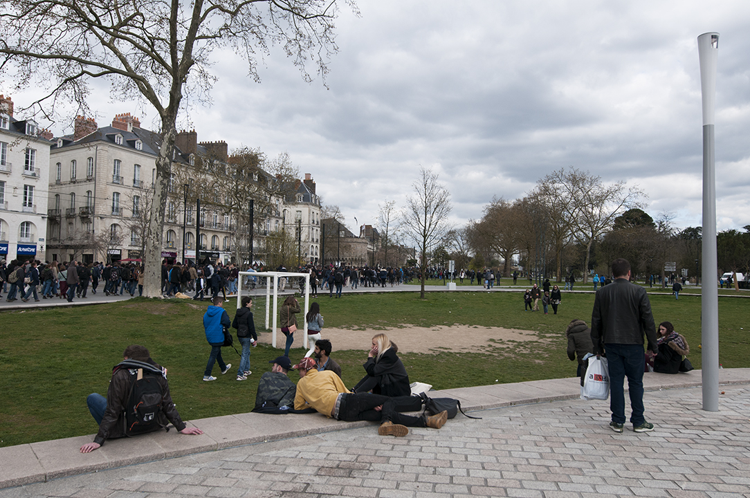 People looking at the protest walk through the city.