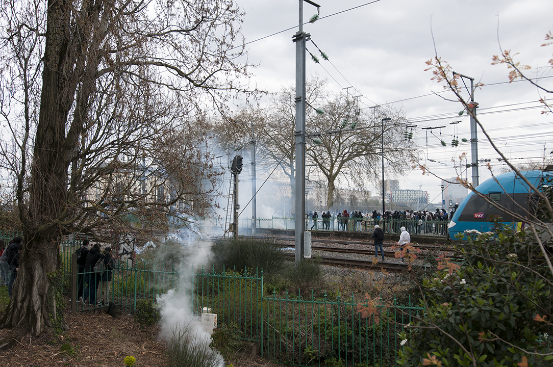 Tear gas fired by the Police to repel the protesters away from the railway.