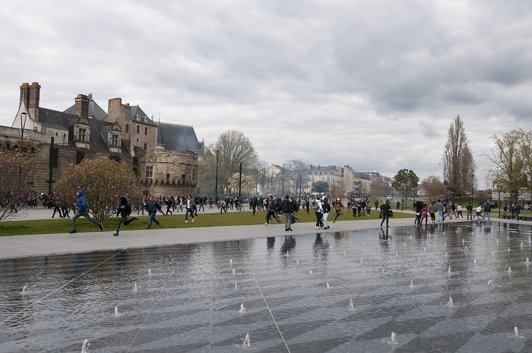 Protesters running away from tear gas in front of the Château des Ducs de Bretagne.