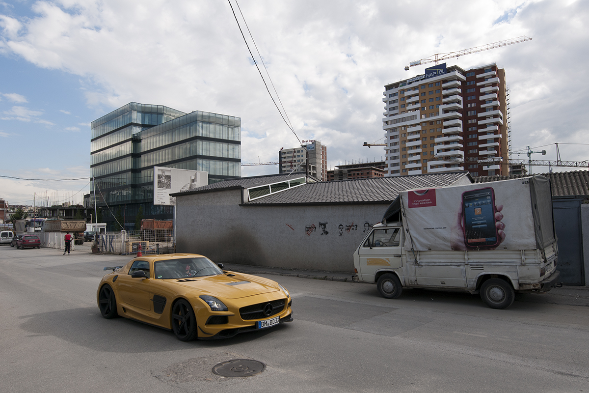 Mercedes AMG with a German number plate driving through a neighborhood under construction.
