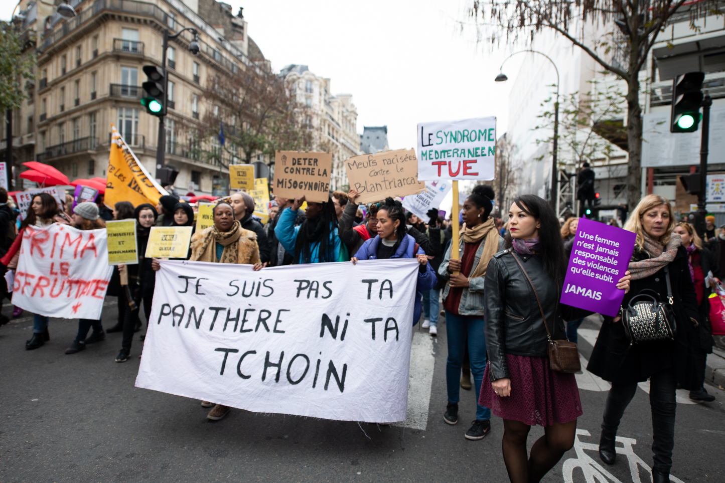 Women holding a banner saying “I am not your panther nor your hoe”.