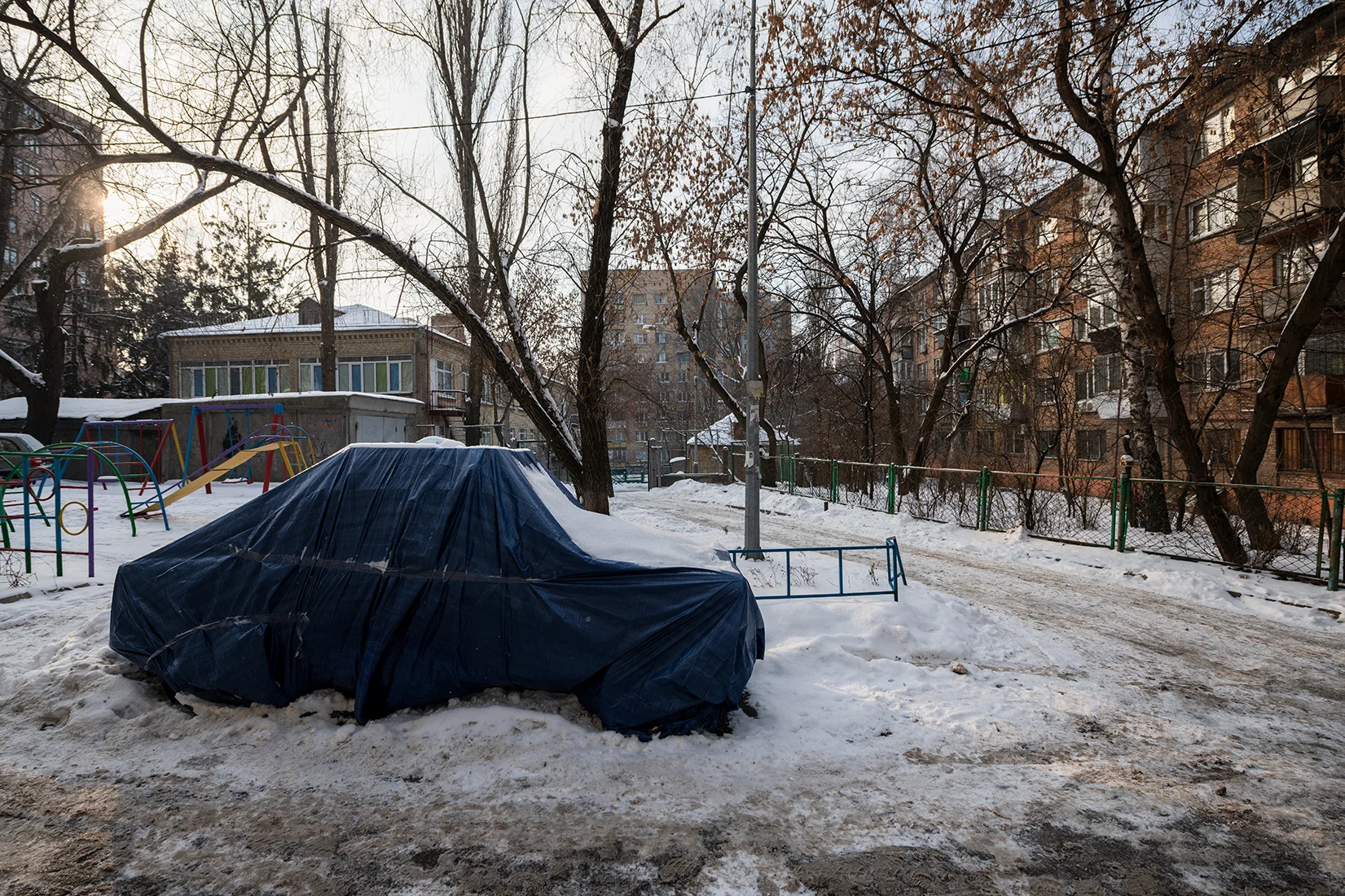 Parked car in a snowy alleyway