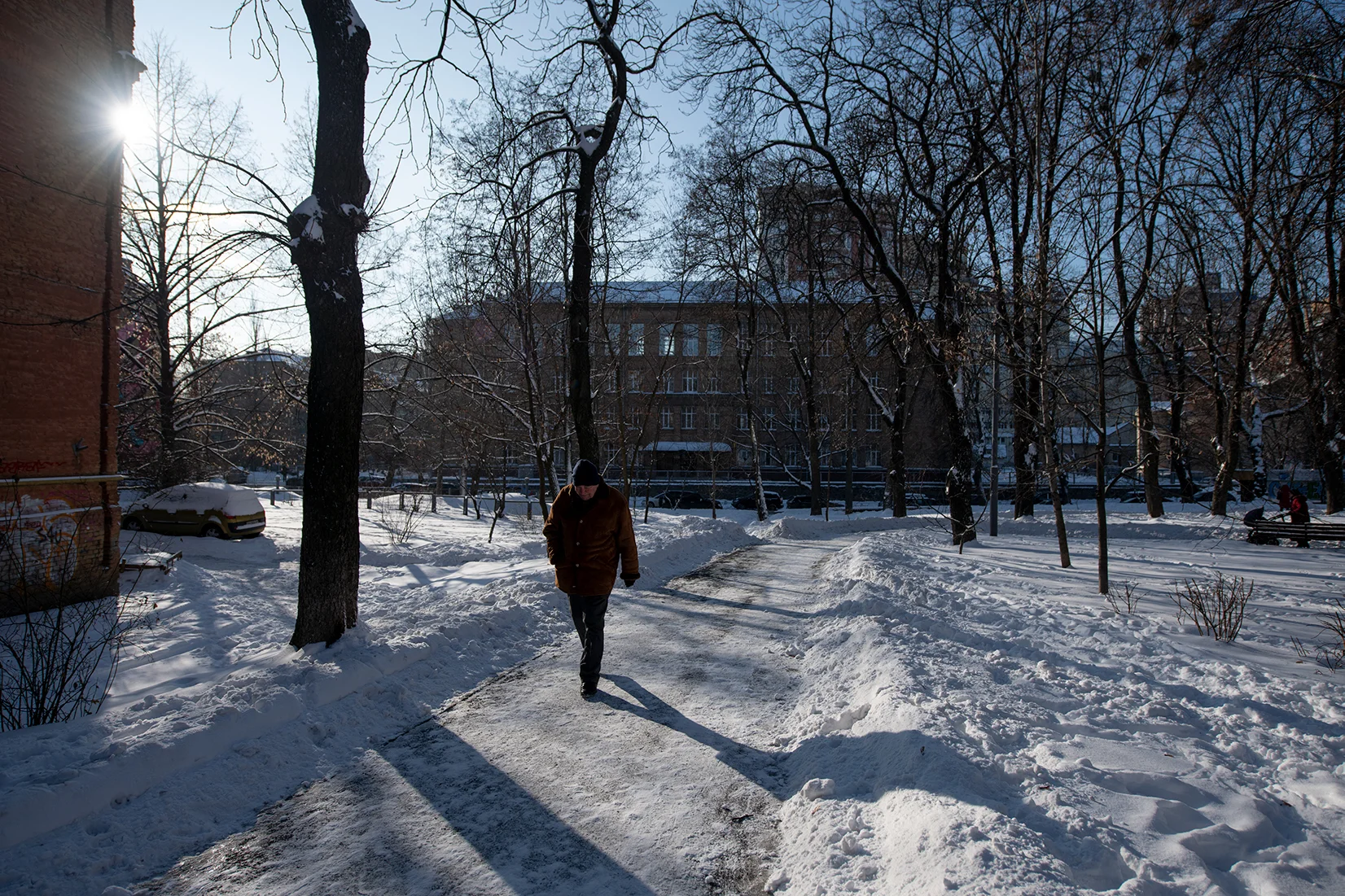 A man walking through Pavlivsʹkyy Sadok park