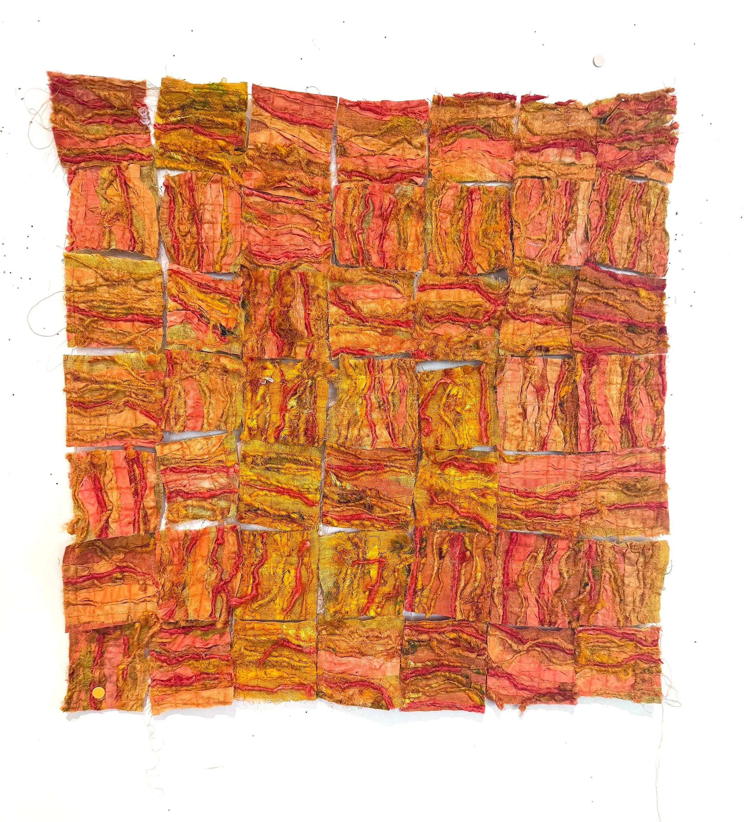 Sculpture of fabric squares in red, orange, and yellow