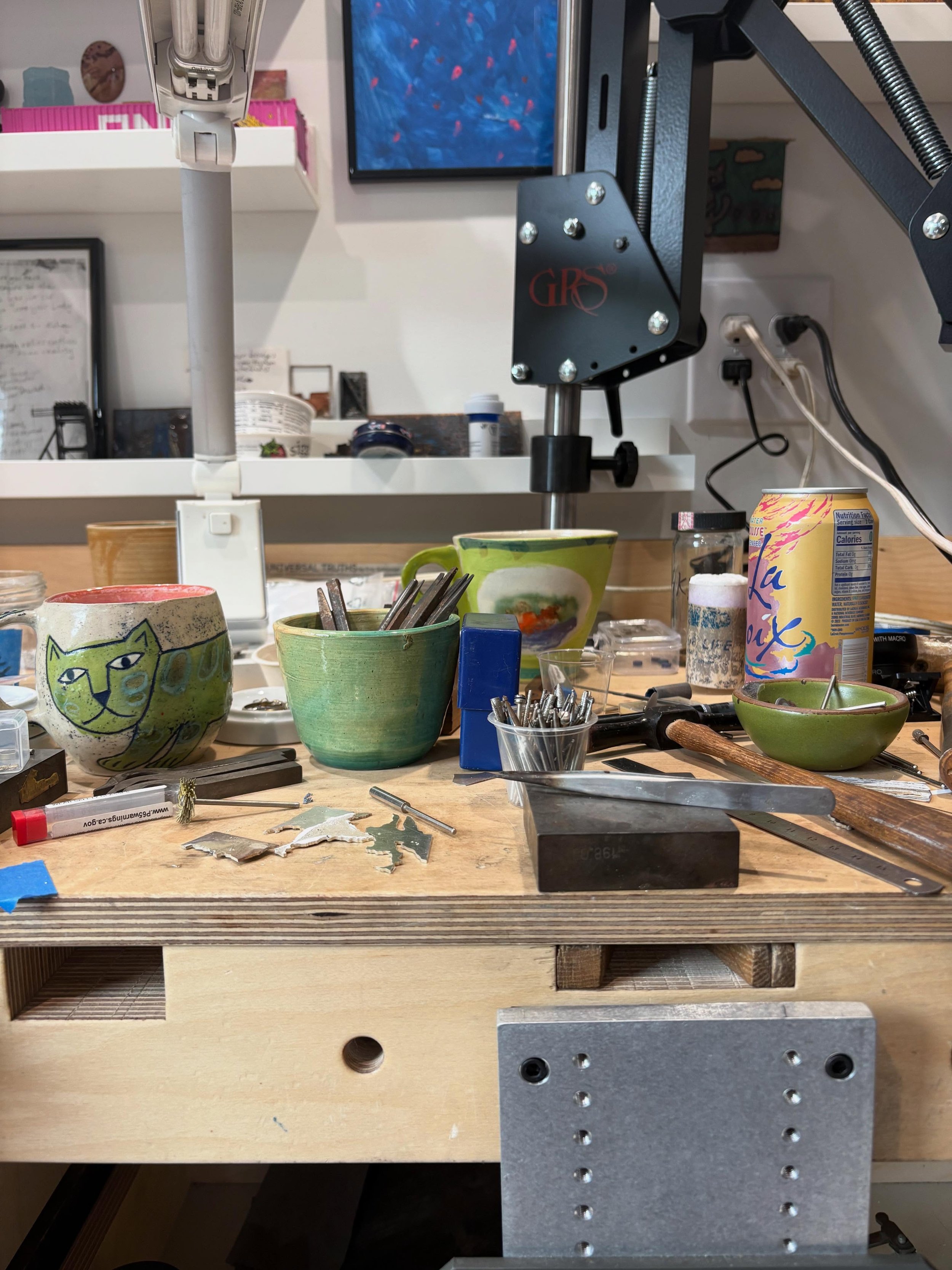 Studio bench behind the scenes: lots of tools and mostly fueled by caffeine and lacroix