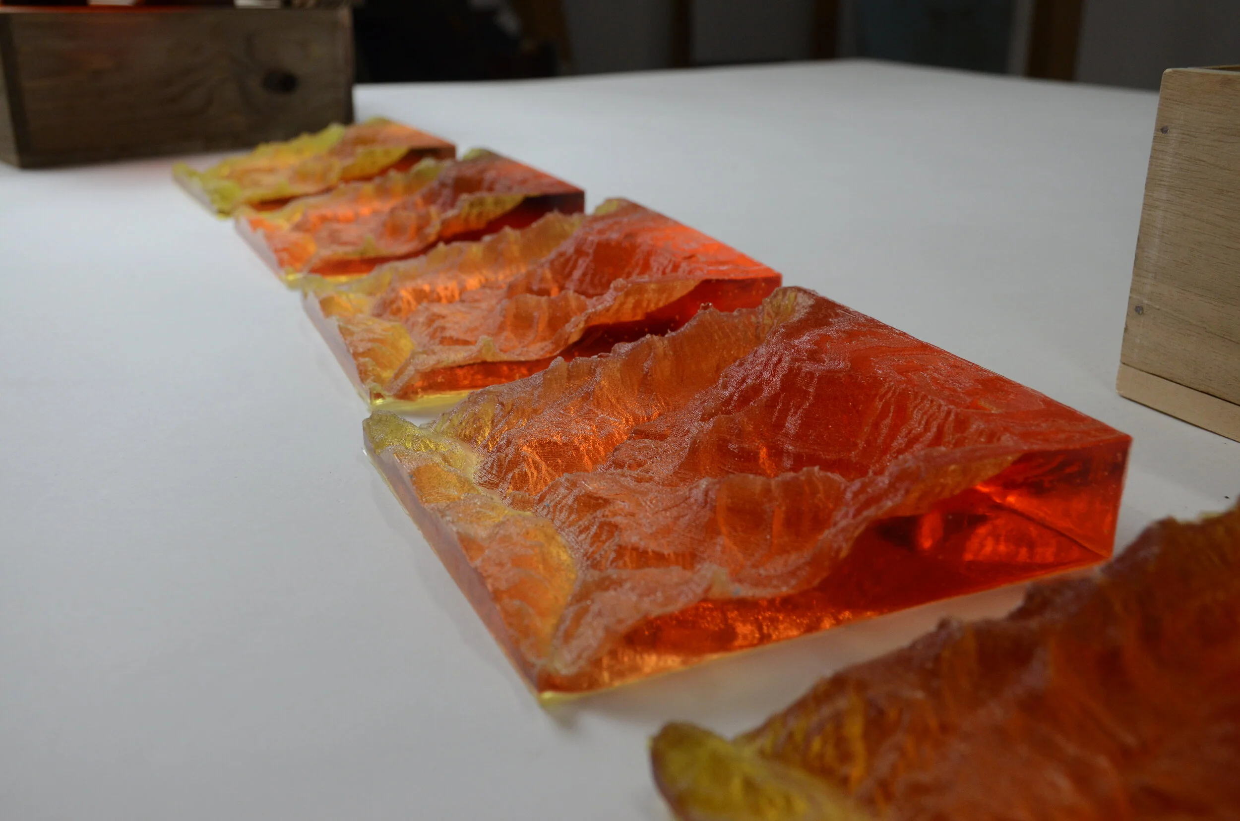 Resin pours of the area the group was visiting were made for each attendee, with a xylene transfer of their itinerary on the inside of their box.