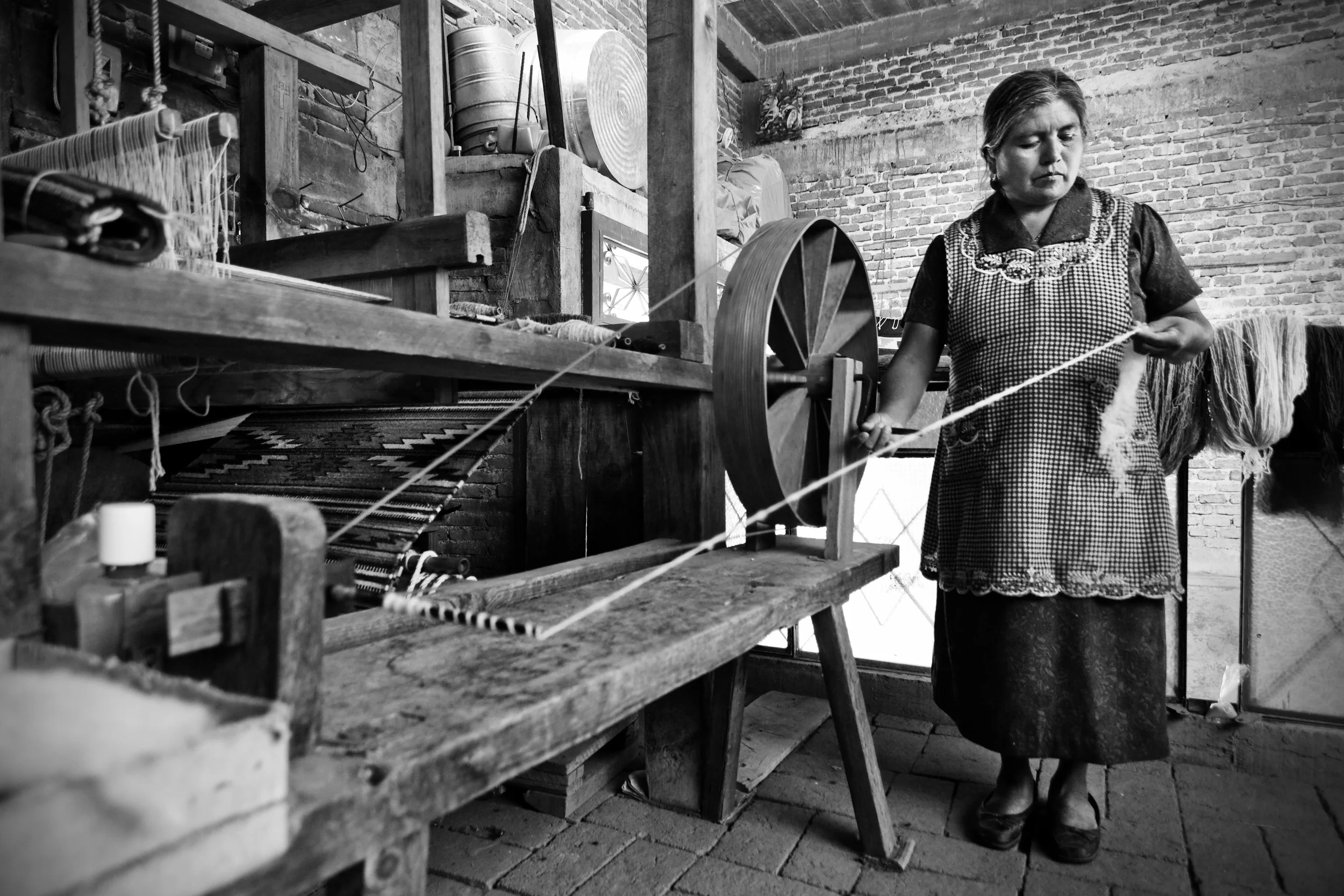1 - Woman spinning wool to make a wool thread.jpg