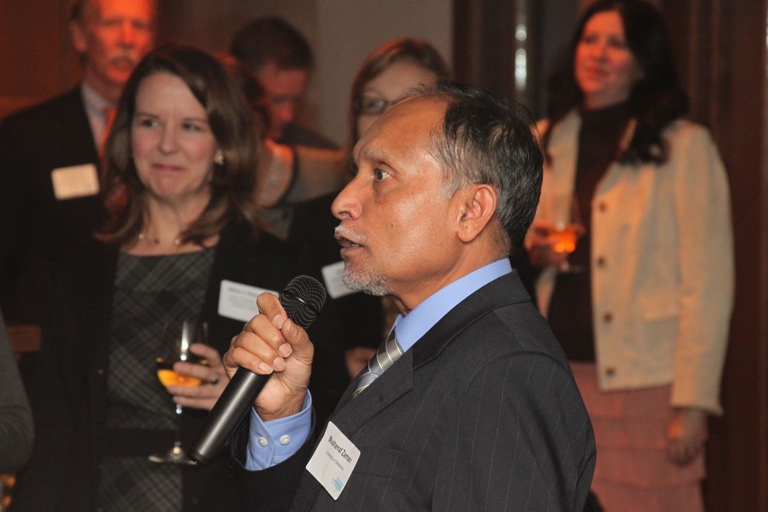 SPTC Director Musharraf Zaman welcomes guests to the kickoff meeting dinner.