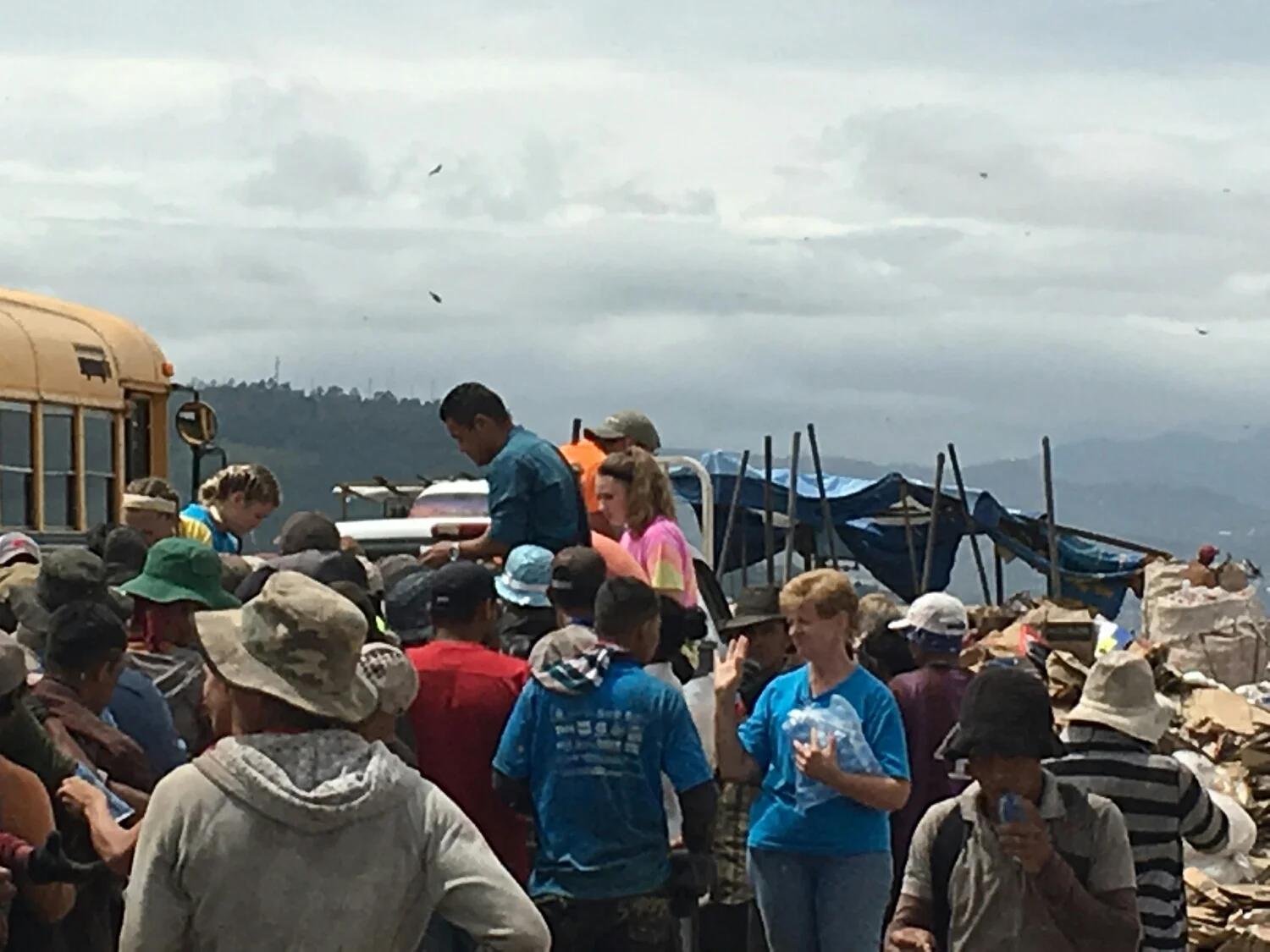 Hannah sat in the back of the pickup & helped distribute a bowl of rice & beans to each person. 