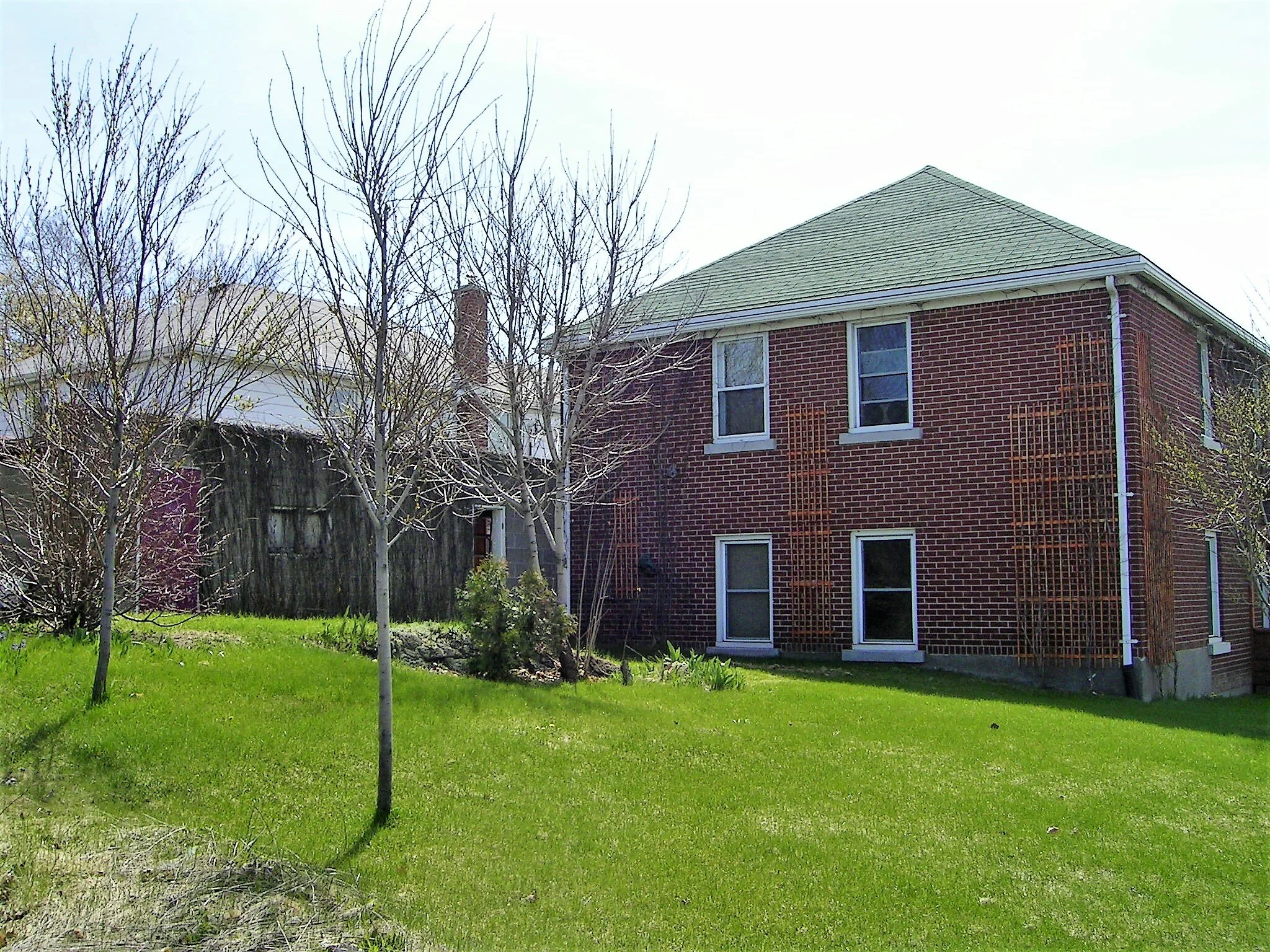 Before construction. You can see the old flat roof one car garage behind the trees.