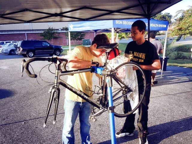 Fixing bikes together – working and learning.
