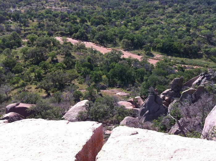 This photo is a crack in the rock face in Enchanted Rock State Park near San Antonio. After making several attempts to climb up the rock face using the crack, my friends and I walked around the rock formation to look down at it from above. The change in perspective was strange. Everything looked different from up above. by Caitlin Eley