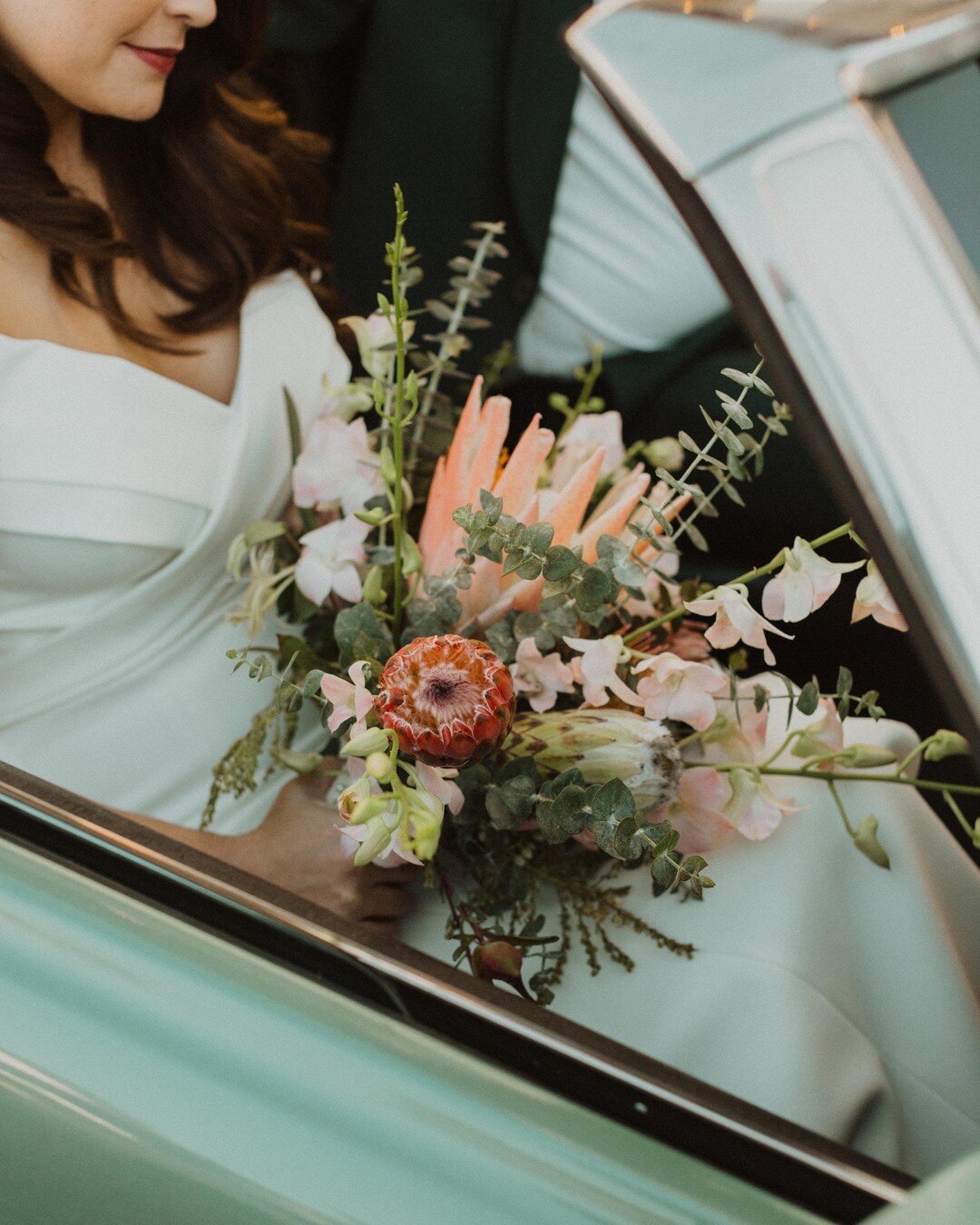 Our sweet bride Ashley with her perfect hair, lips, bouquet and convertible mustang. Love watching you and Ryan enjoy life with that new cute baby Marley!