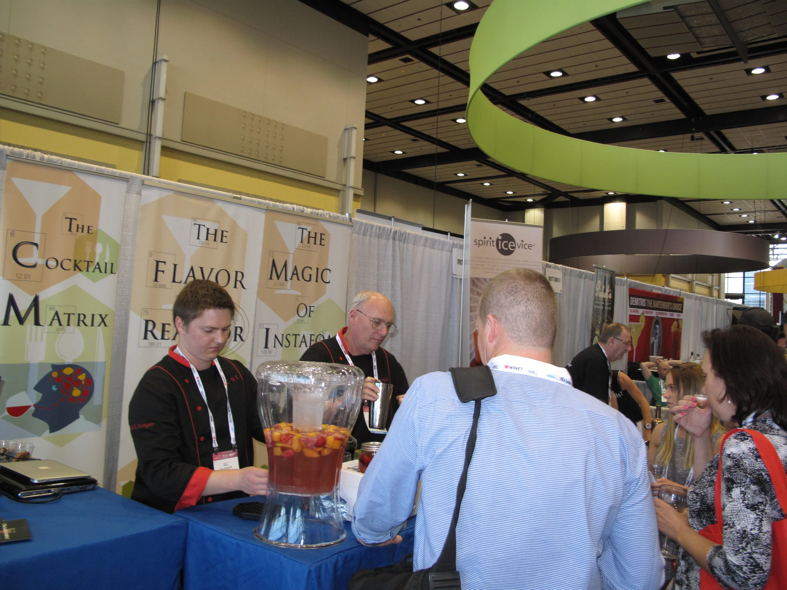 Eli Munger, CSI chemist pouring cantaloupe syrup made in the Flavor Reactor and Roy Porter serving whiskey sours made with InstaFoam and Umami Drops to attendees.