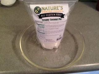 Nice easy bag for pouring, an eco bag would be nice. Or reusable. Grease the glass dish!
