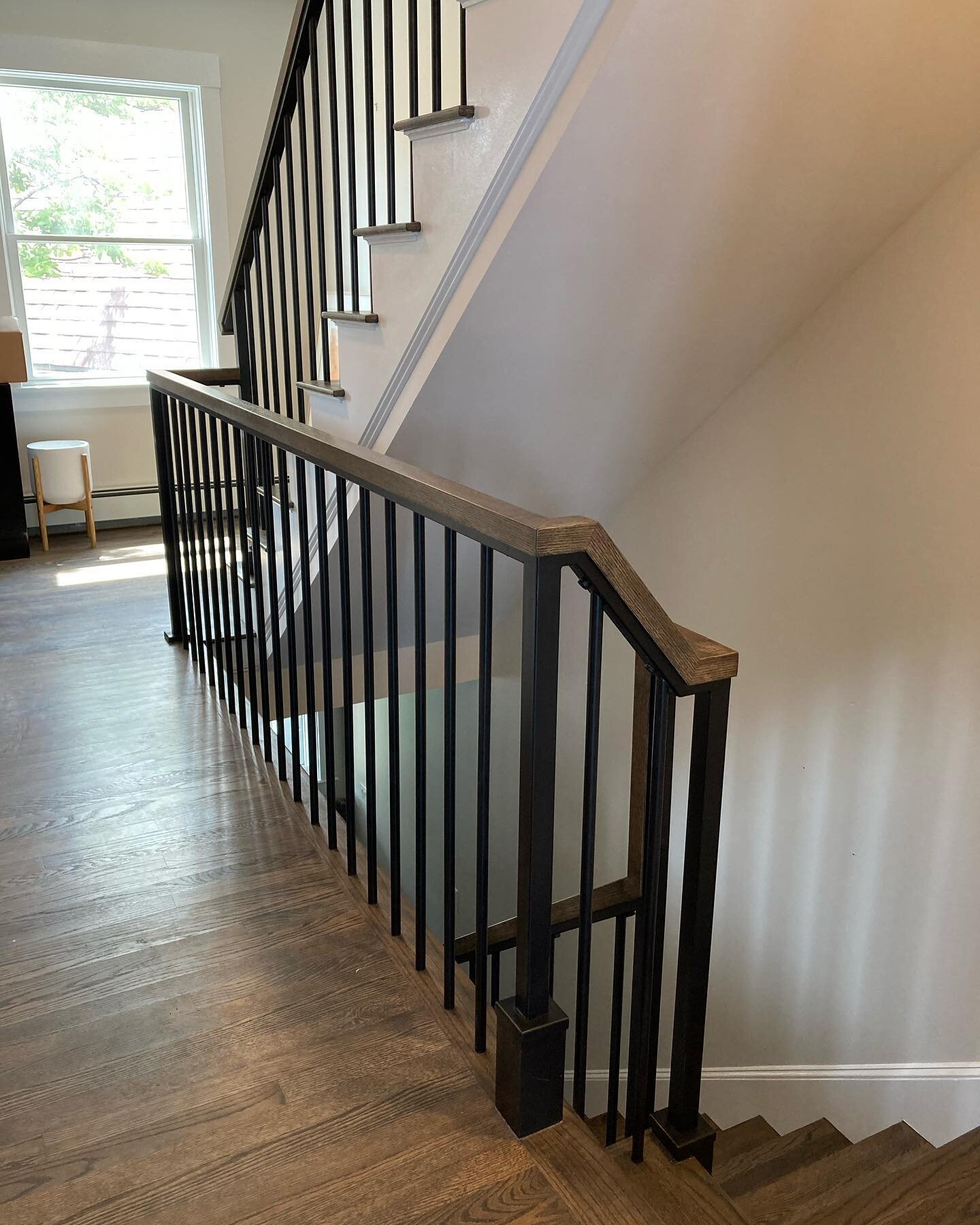 Handrail completed in south portland. Tough build. Had to use existing holes in the flooring from the original wood railing, insert matching diameter rods and weld all parts on site. Wood cap wraps around the top, stained to match tread color. Great 