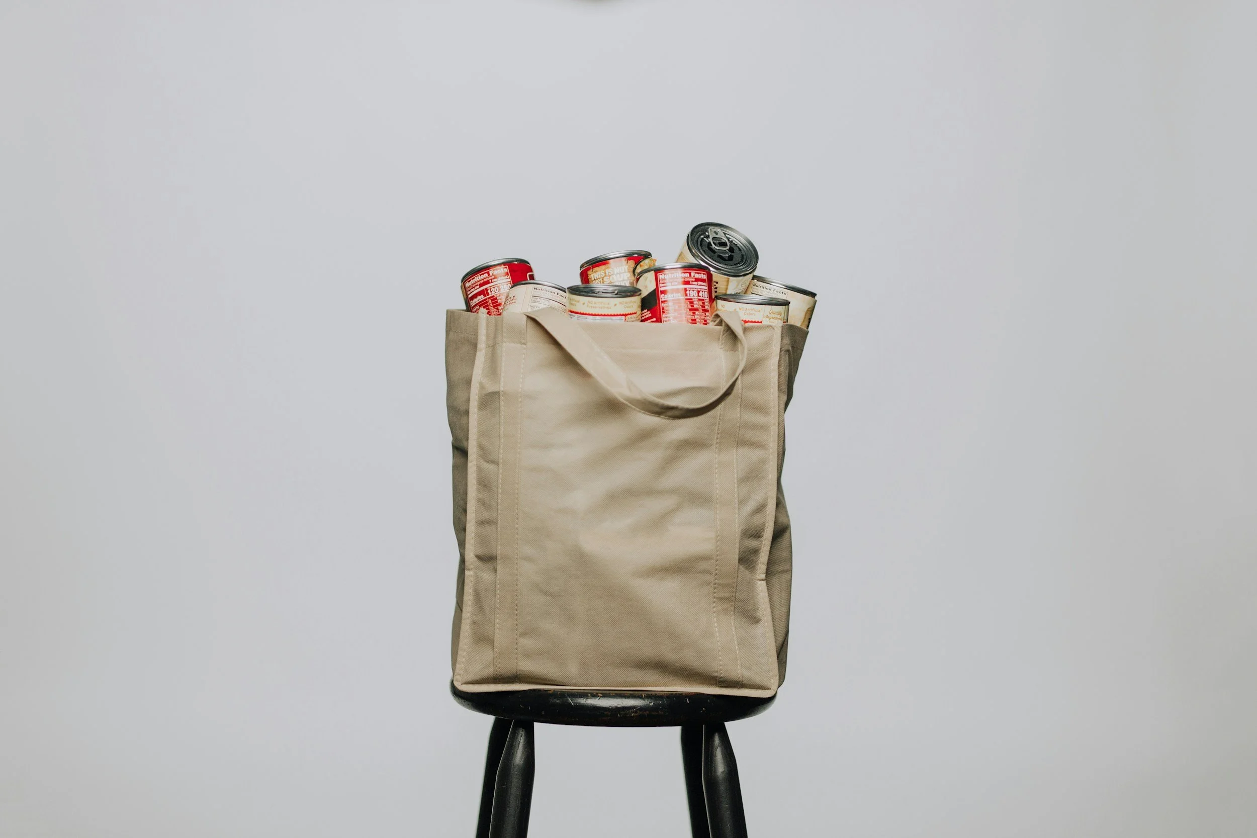 reusable shopping bag filled with cans