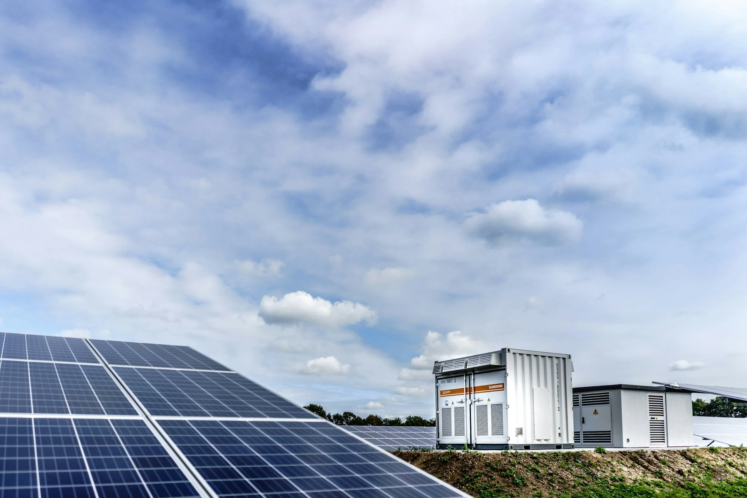 solar panels under a blue and cloudy sky