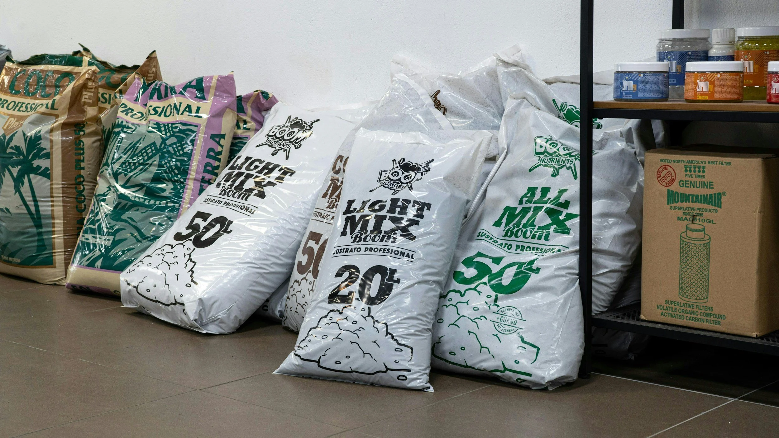 bags of soil li ned up in a garage