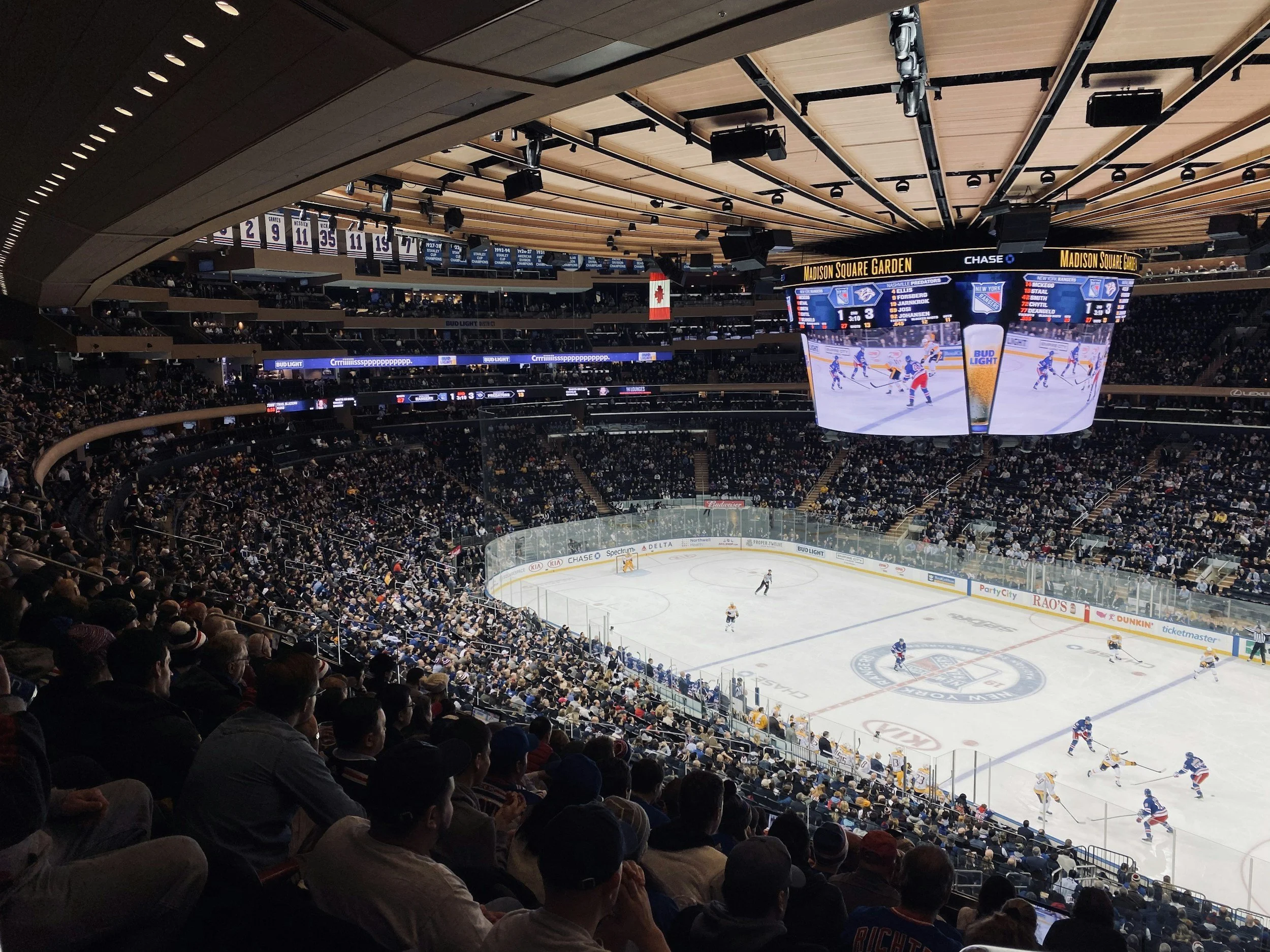 hockey arena with spectators and canadian flag