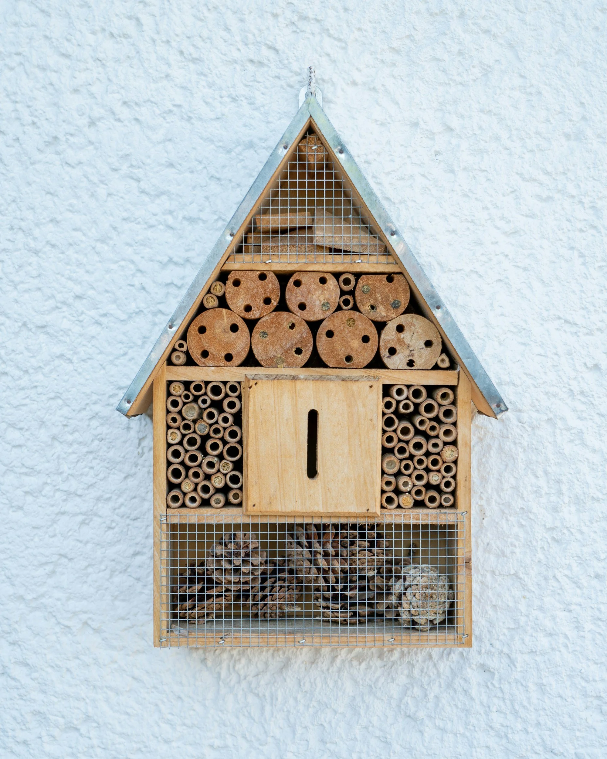 a bee hotel shaped like a house