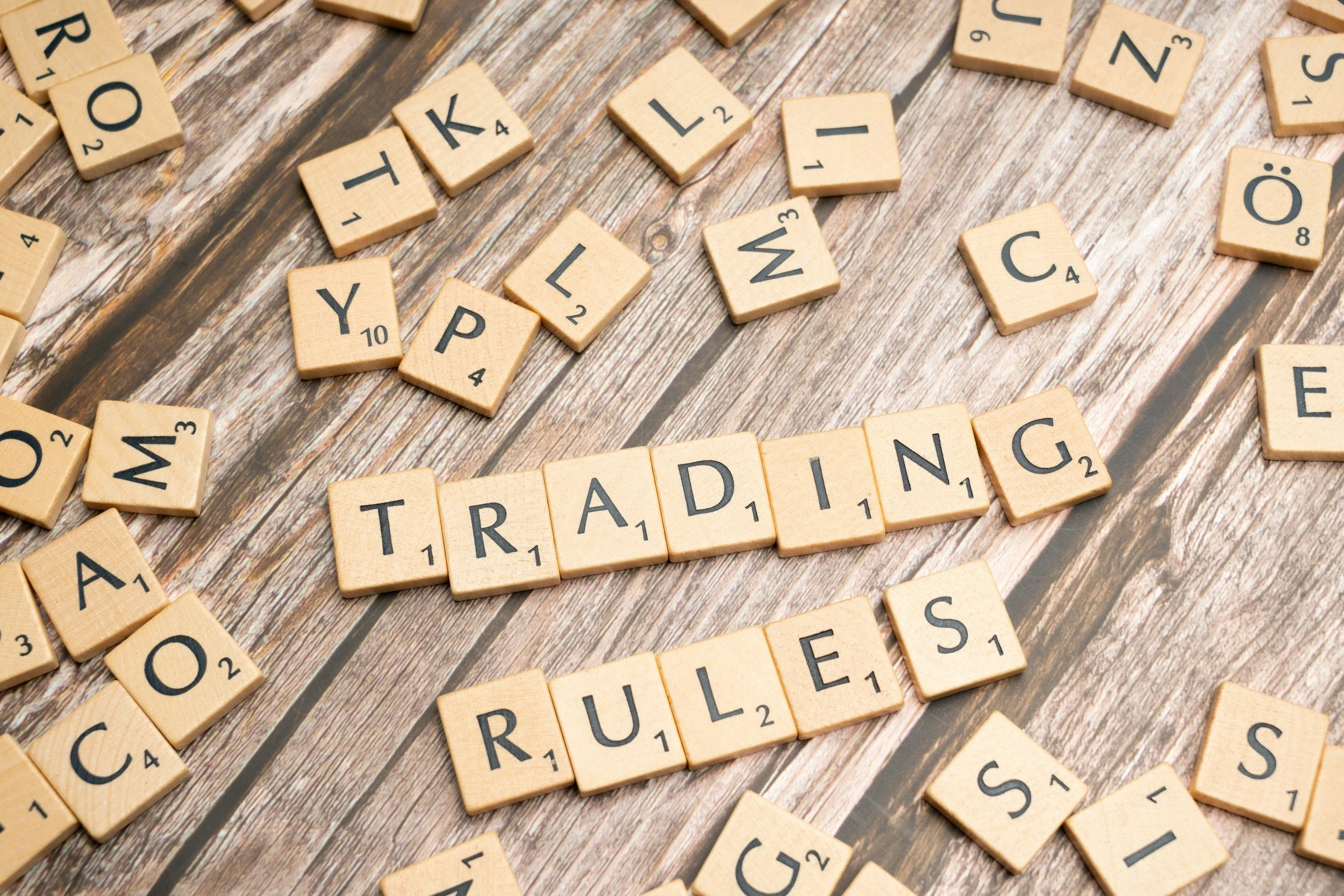 scrabble tiles spelling out trading rules