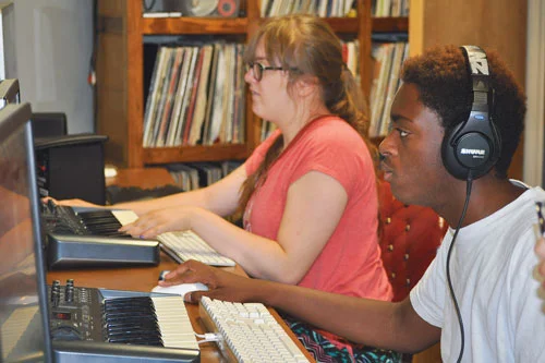 Students at Neutral Zone’s music video camp 2017 composing at beat making stations