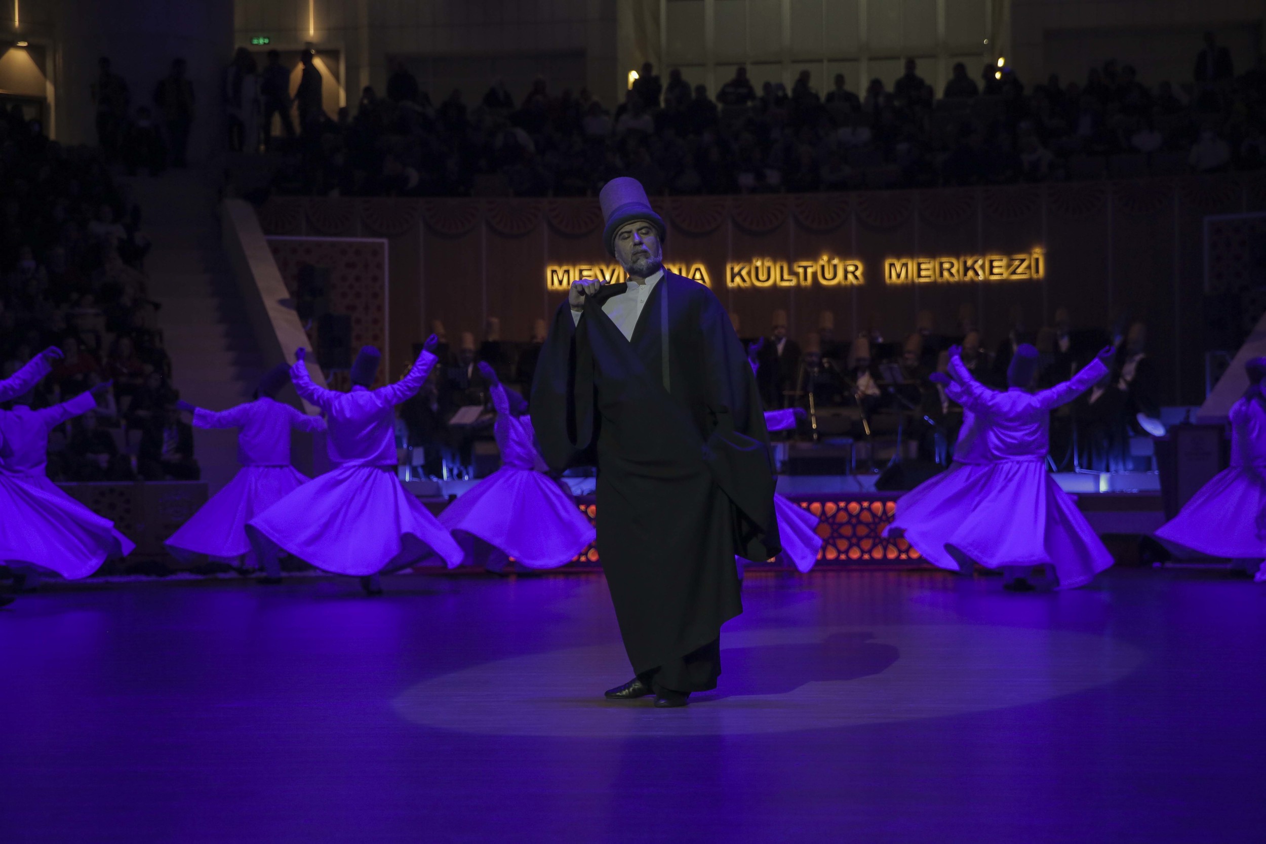 Fahri Ozcakil, the Dede – or head – of the whirling Dervishes and father of Mithat, gently turning in the centre of the other whirling dervishes